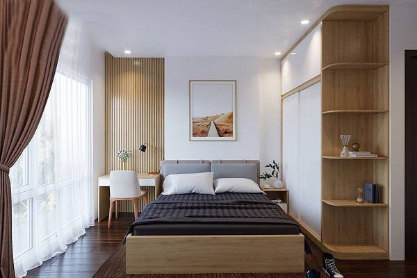 A bedroom with a bed and a desk Description automatically generated