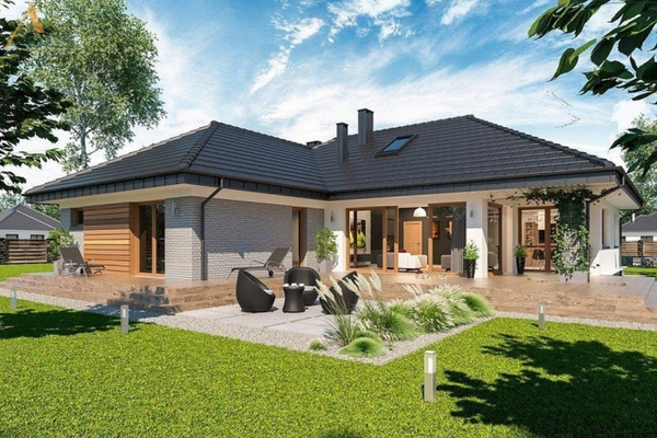 A house with a lawn and trees Description automatically generated