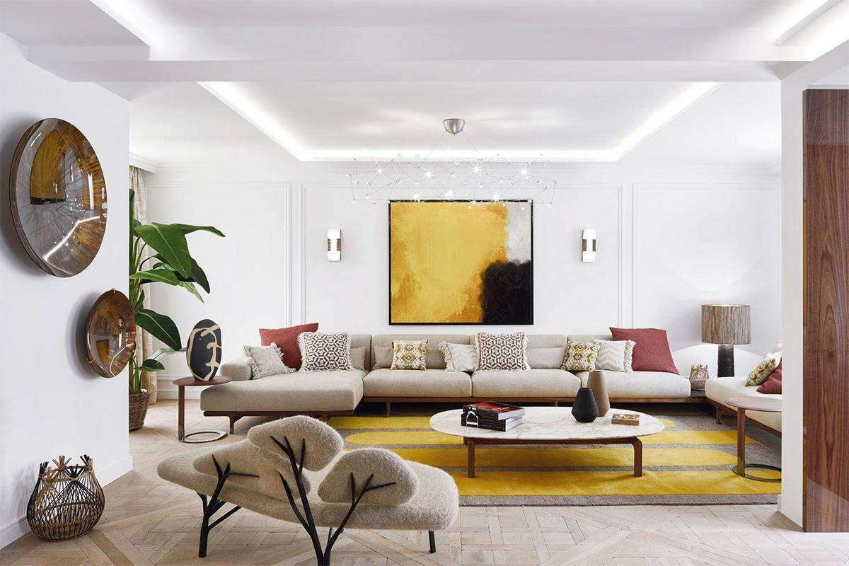 A living room with a large couch and a painting
Description automatically generated