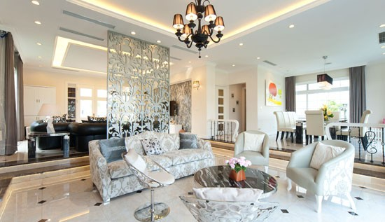 A living room with a large table and chairs Description automatically generated