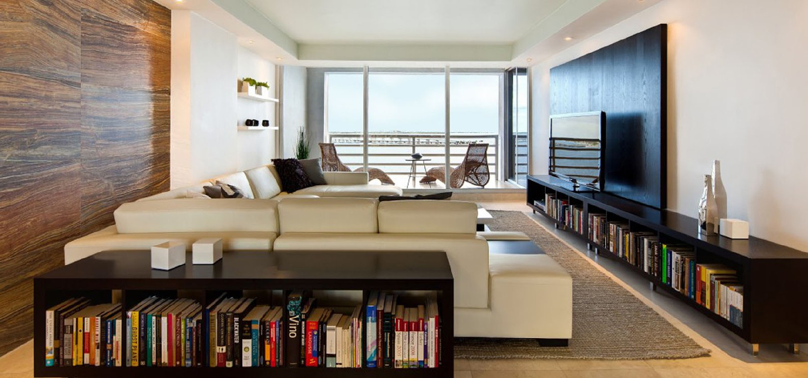 A living room with a large window Description automatically generated