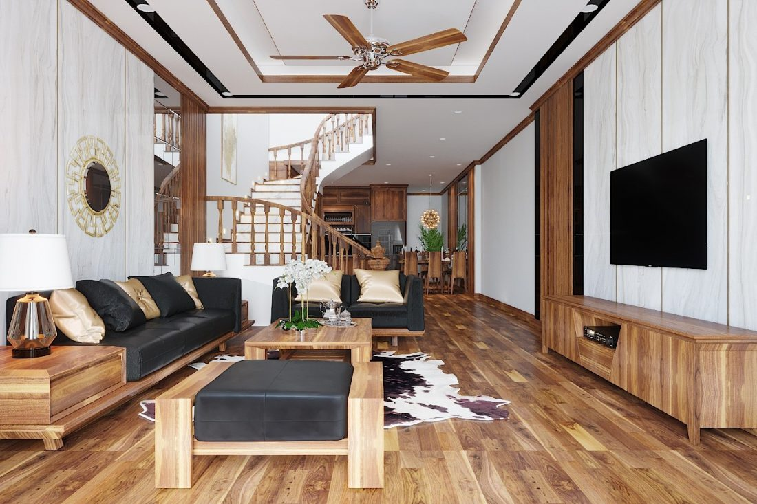 A living room with a television and a staircase Description automatically generated