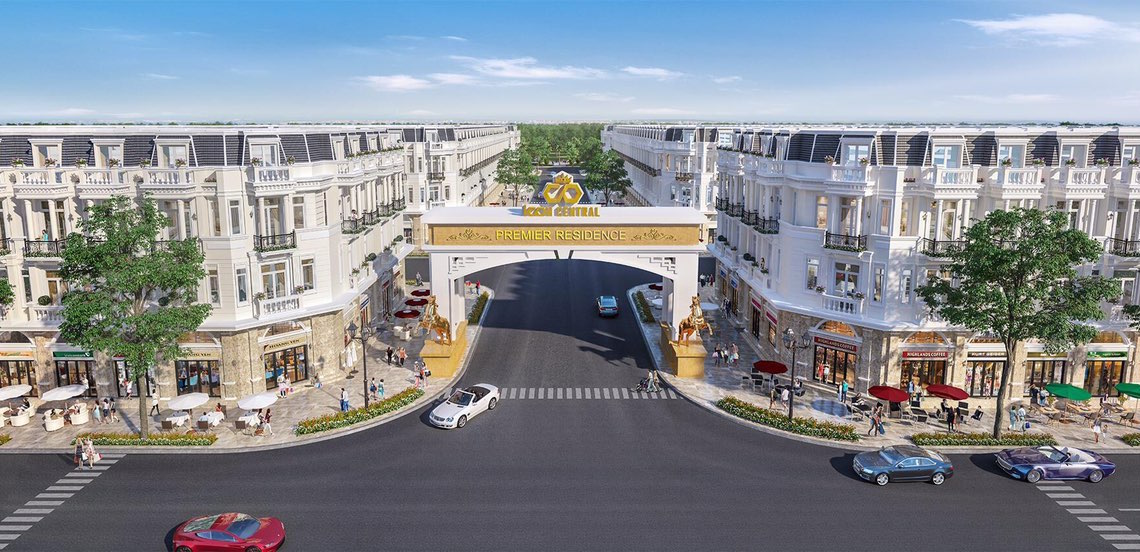 A street with cars and buildings Description automatically generated