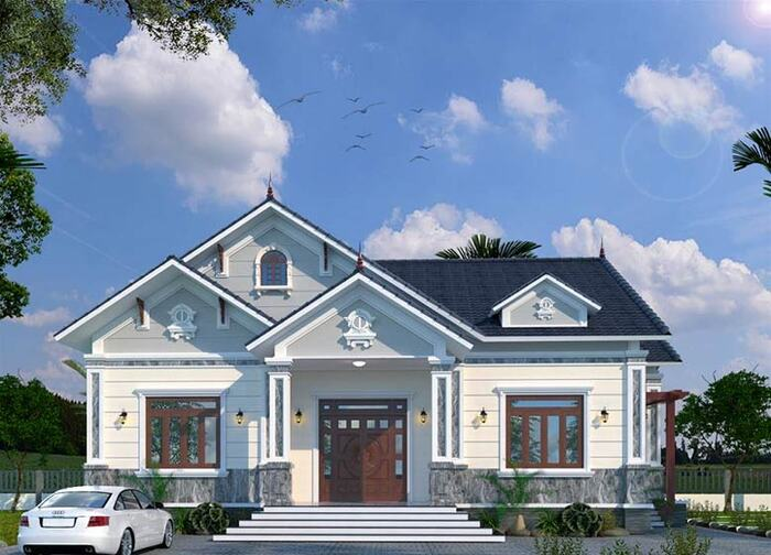 A white house with a car parked in front of it Description automatically generated